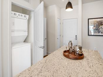 a kitchen with white appliances and a counter top